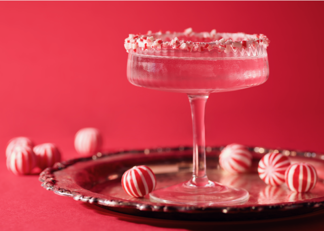 Pink cocktail in coupe glass with sugared rim photographed on red background for commercial drink advertising