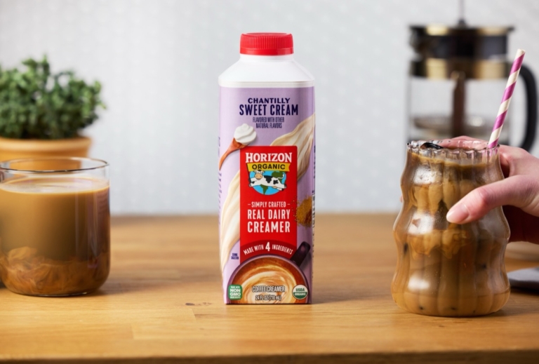 Horizon Organic Chantilly Sweet Cream carton displayed between iced coffee drinks on wood surface.