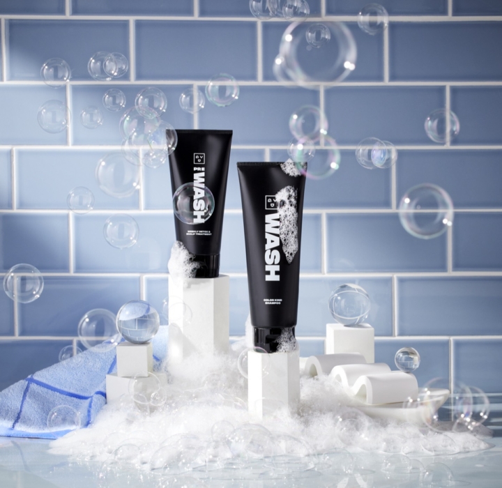 WASH and RINSE cosmetic products photographed with ice, foam, and water against a clean tiled background