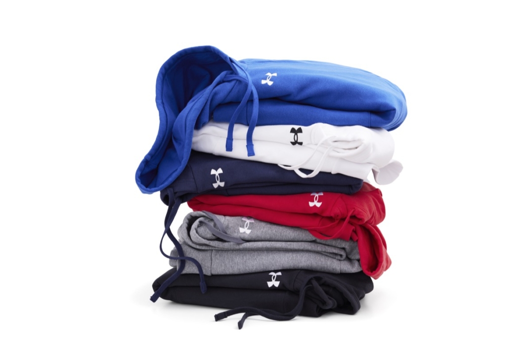 Stack of folded shirts in different colors including red, blue, and white