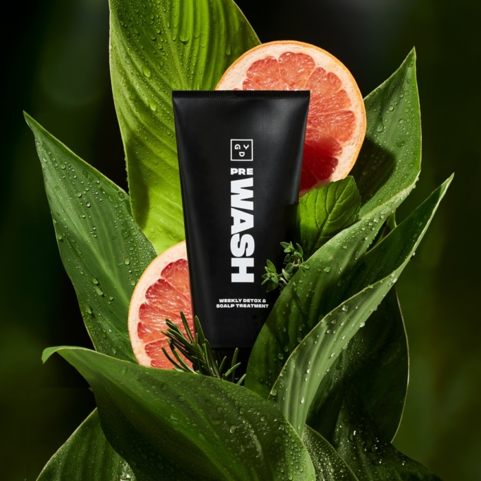 Good Dye YoungWash cleanser tube photographed with citrus and botanical styling for commercial advertising