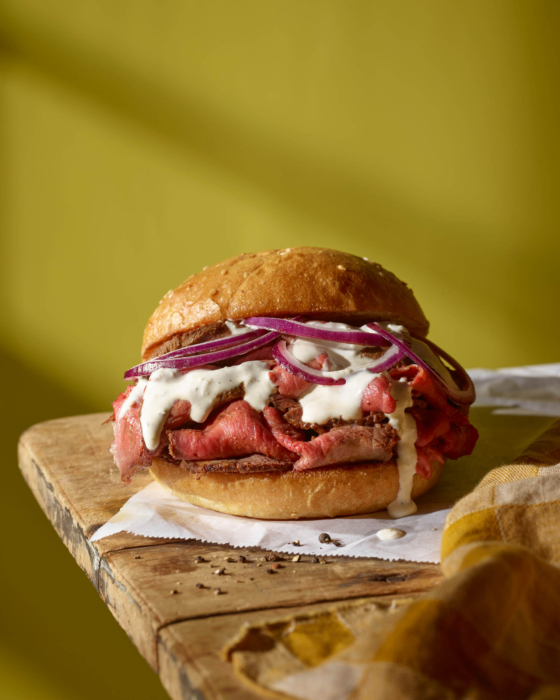 Roast beef sandwich with sauce and slaw — commercial food photography by OMS Photo