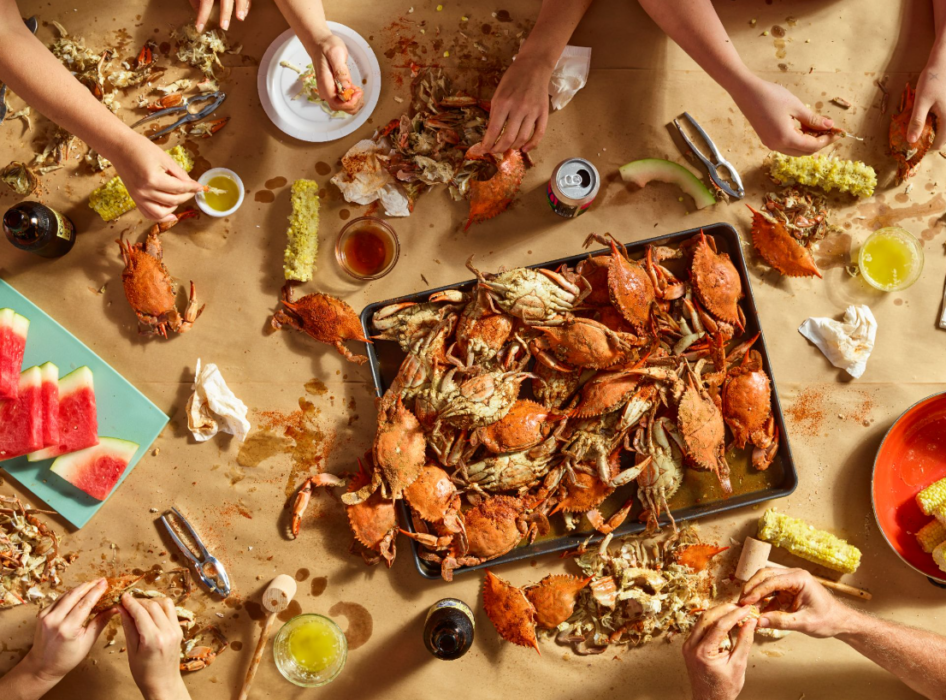 Overhead view of seafood boil shared at table — commercial food photography by OMS Photo
