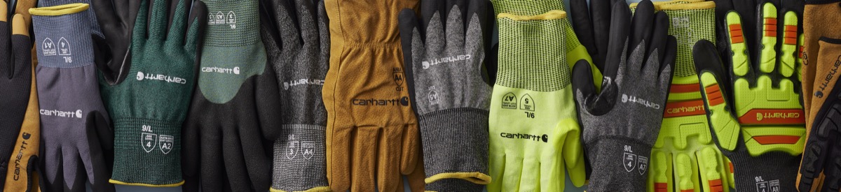 Close-up of three Carhartt work gloves showing brown leather, gray knit, and yellow hi-vis styles with Carhartt branding