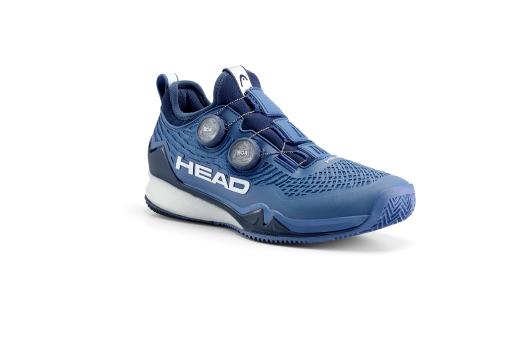 Blue HEAD tennis shoe side view showing white sole and dual BOA closure dials on white background