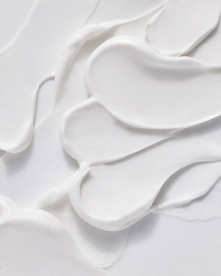 Close-up of Naked & Thriving moisturizer cream texture swirl on white background
