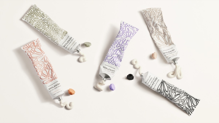 Naked & Thriving skincare tubes and serum bottle flat lay on white background with small details