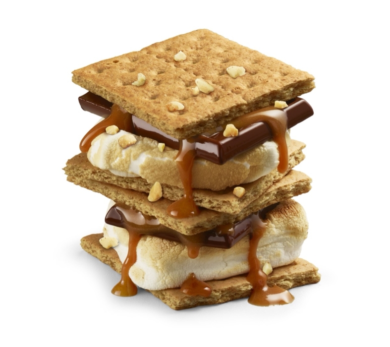 Stacked double s'mores with graham crackers, toasted marshmallow, chocolate, caramel drizzle, and chopped peanuts