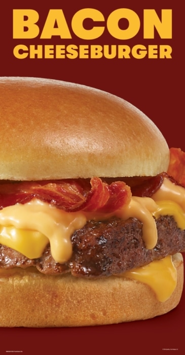 Wendy's bacon cheeseburger with melted American cheese and crispy bacon close-up macro food photography on warm red background
