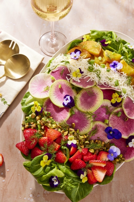 Overhead shot of 80 Acres Farms salad with edible flowers, watermelon radish, and mixed greens