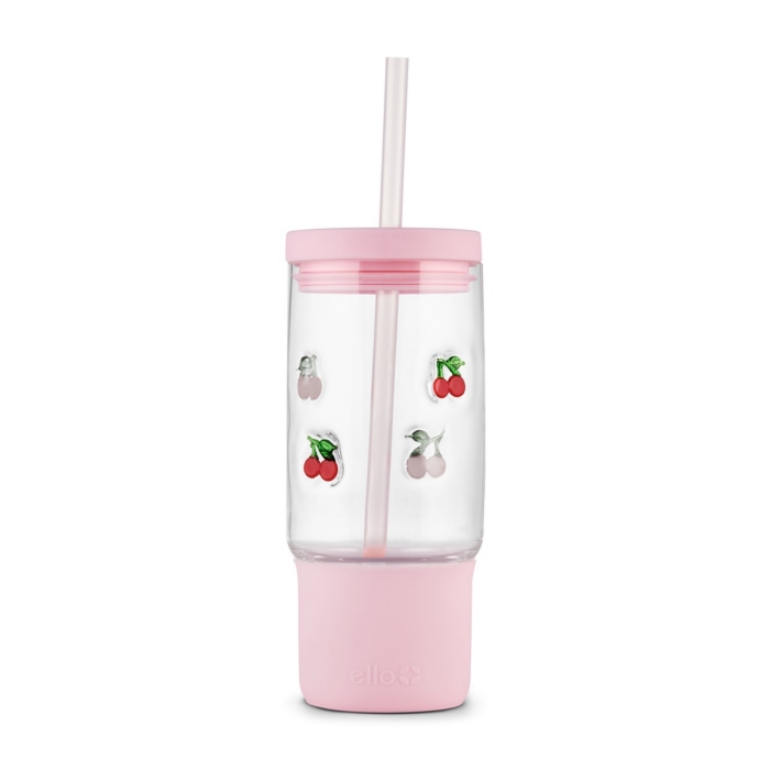 Clear Ello glass tumbler with cherry charm decorations, pink silicone sleeve, lid, and straw on white background