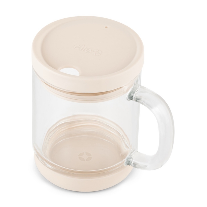 Overhead angle of empty glass coffee mug with blush silicone lid on and non-slip silicone base