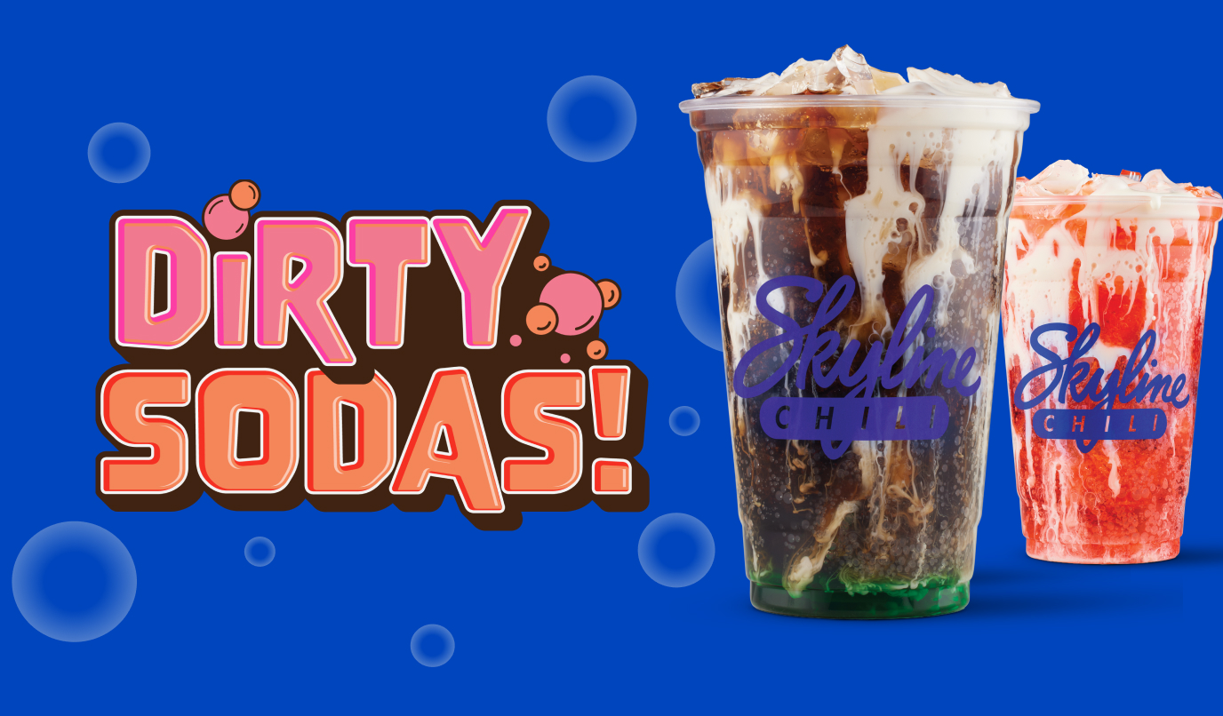 Assortment of dirty sodas in clear cups with ice and fruit garnish styled on a surface