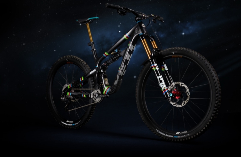 Full drive-side studio portrait of Yeti SB160 Richie Rude 2025 EDR World Champion Special Projects mountain bike against starfield background, showing Shimano XTR drivetrain, Fox 40 fork, DT Swiss Schwalbe Gravity Pro wheelset, and complete UCI rainbow stripe livery