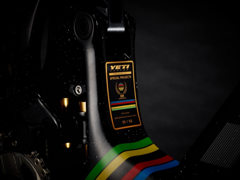 Gold Yeti Cycles Special Projects numbered plaque on SB160 carbon frame reading "Richie Rude – 2025 EDR World Champion SB160 – 01/02" with UCI rainbow stripe detail, photographed in dramatic studio lighting
