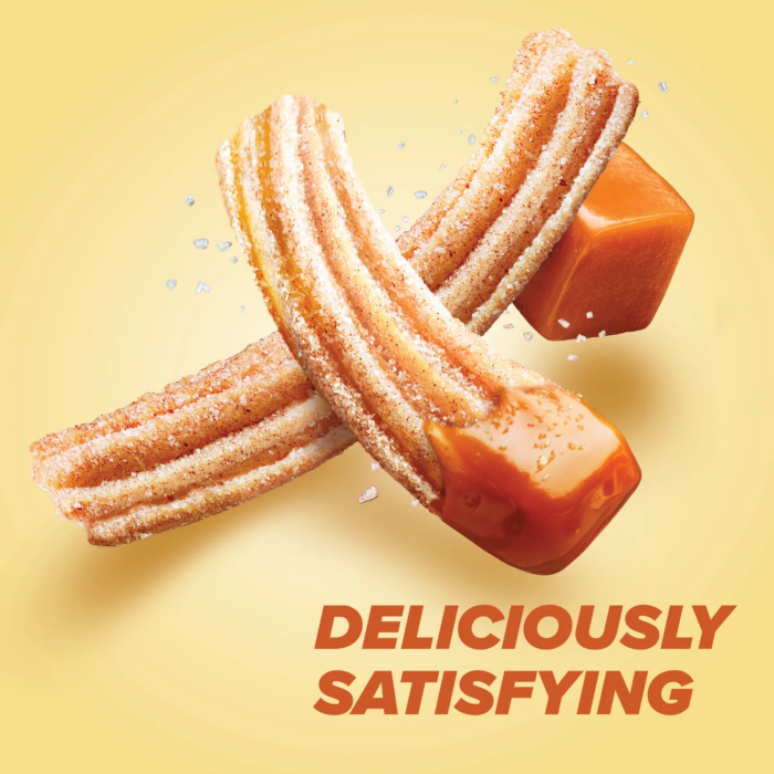 Pure Protein churro caramel protein bar styled with churros and caramel drizzle on yellow background