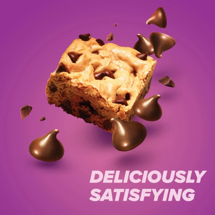 Pure Protein Chewy Chocolate Chip protein bar with chocolate chips on purple background