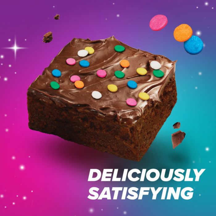 Pure Protein cosmic brownie-style chocolate protein bar with colorful candy pieces on purple background