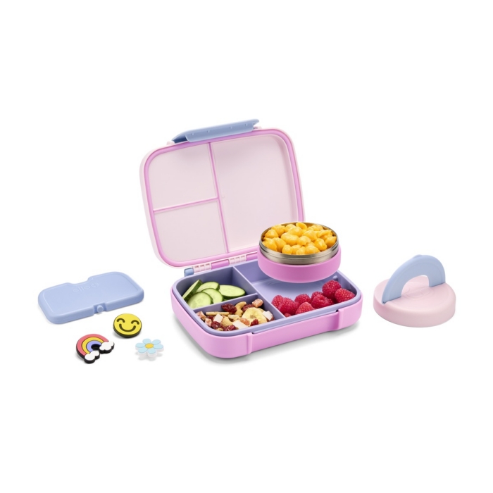 Pink Ello bento lunch box at angled view packed with mac and cheese, raspberries, cucumbers, and trail mix beside stacked lids and charms