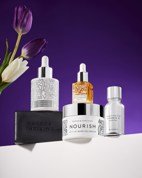 Naked & Thriving Nourish skincare serum and facial oil collection on deep purple background