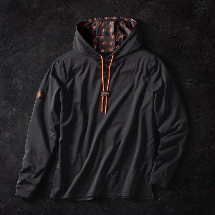 Charcoal gray hooded long sleeve shirt with orange drawstrings and star-patterned hood lining, laid flat on dark stone background