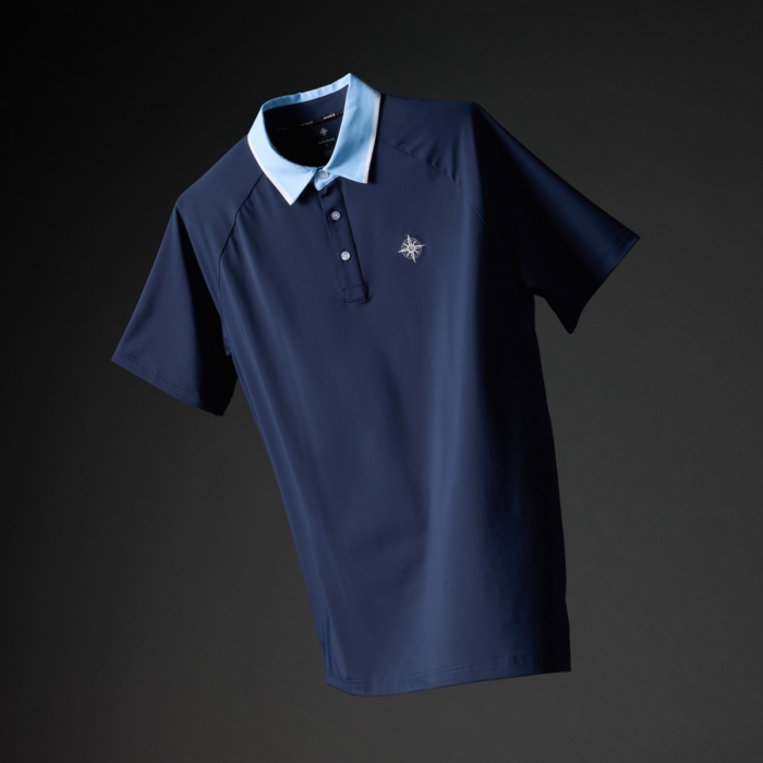 Navy blue golf polo shirt with light blue and white striped collar and embroidered compass logo on a dark background
