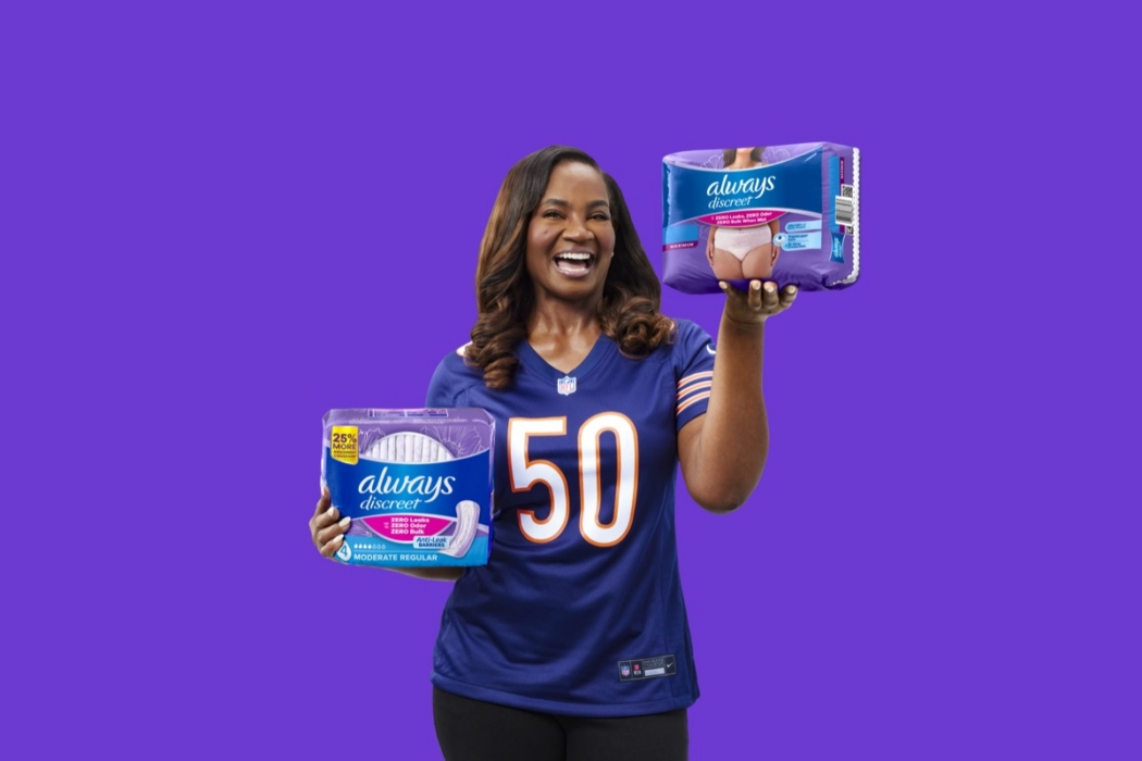 Elisha Jarrett holds Always Discreet pads and underwear while wearing a Chicago Bears jersey for the Always Discreet NFL campaign.
