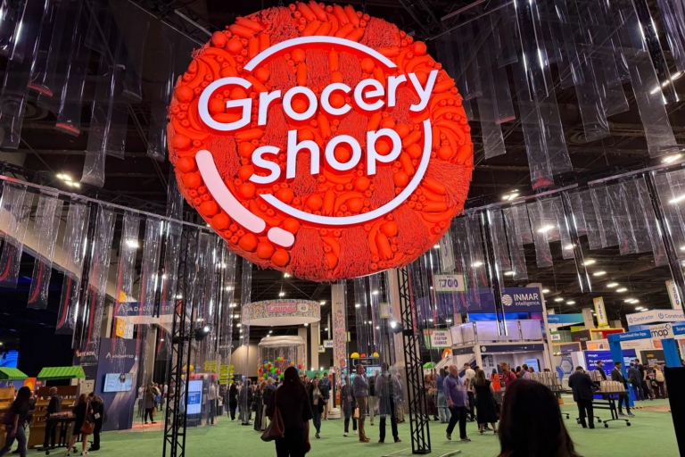 Groceryshop conference entrance and exhibition floor with retail, CPG and commerce technology professionals attending the industry event.