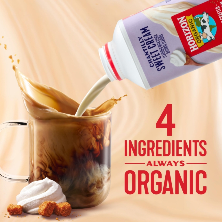 Horizon Organic creamer pouring into a glass of iced coffee with a dramatic liquid splash against a warm beige background.